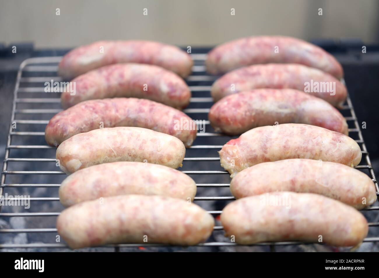 Fresh sausage grilling. Stock Photo