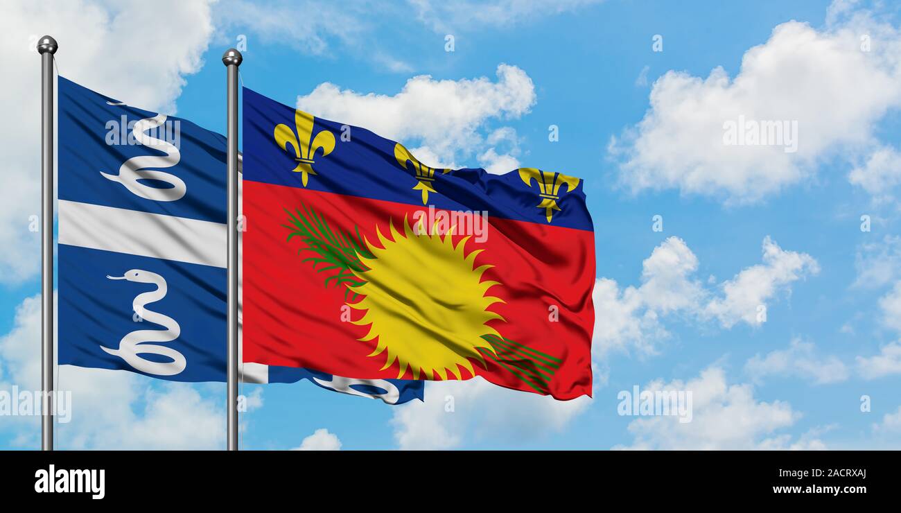 Martinique and Guadeloupe flag waving in the wind against white cloudy