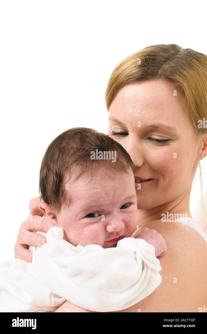 Mother with infant on shoulder Stock Photo