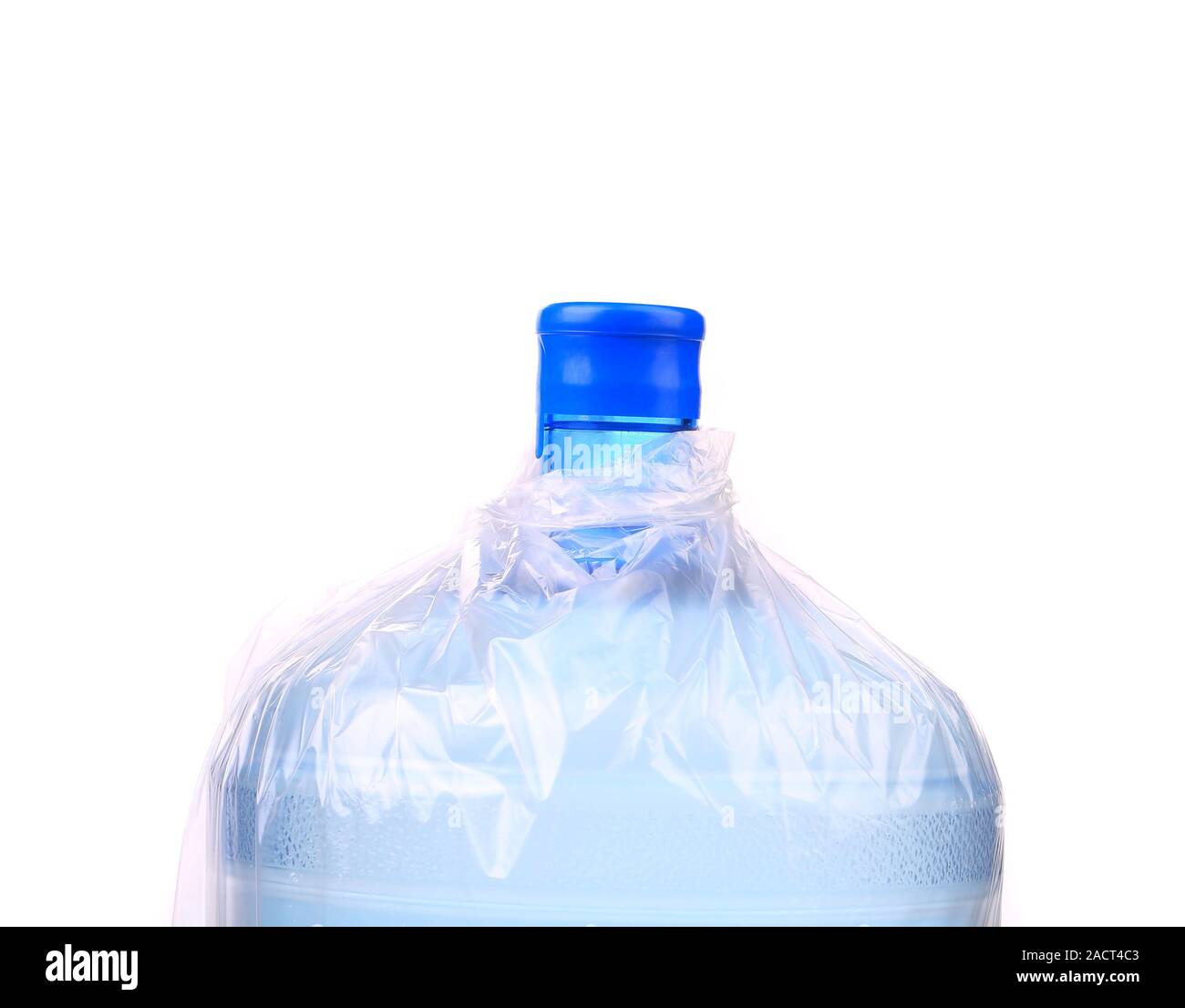 Big plastic bottle with water on the table over bright kitchen backgroung.  Bottle of clear transarent water in a blue color cap and handle closeup  Stock Photo - Alamy