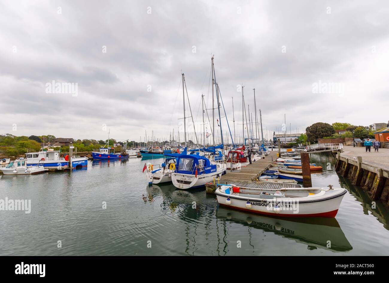 Sailing boats moored at a pontoon in the harbour at Lymington on the Solent, New Forest District, Hampshire on the south coast of England Stock Photo