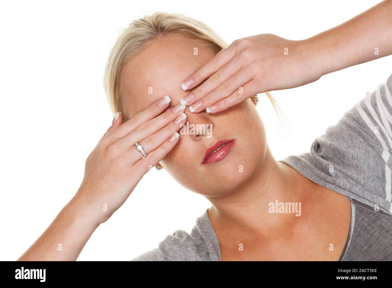 Woman keeps her eyes closed Stock Photo