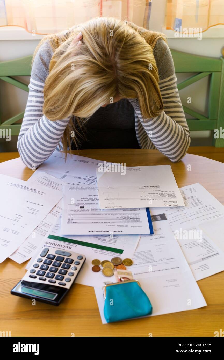 Woman with debts and bills Stock Photo