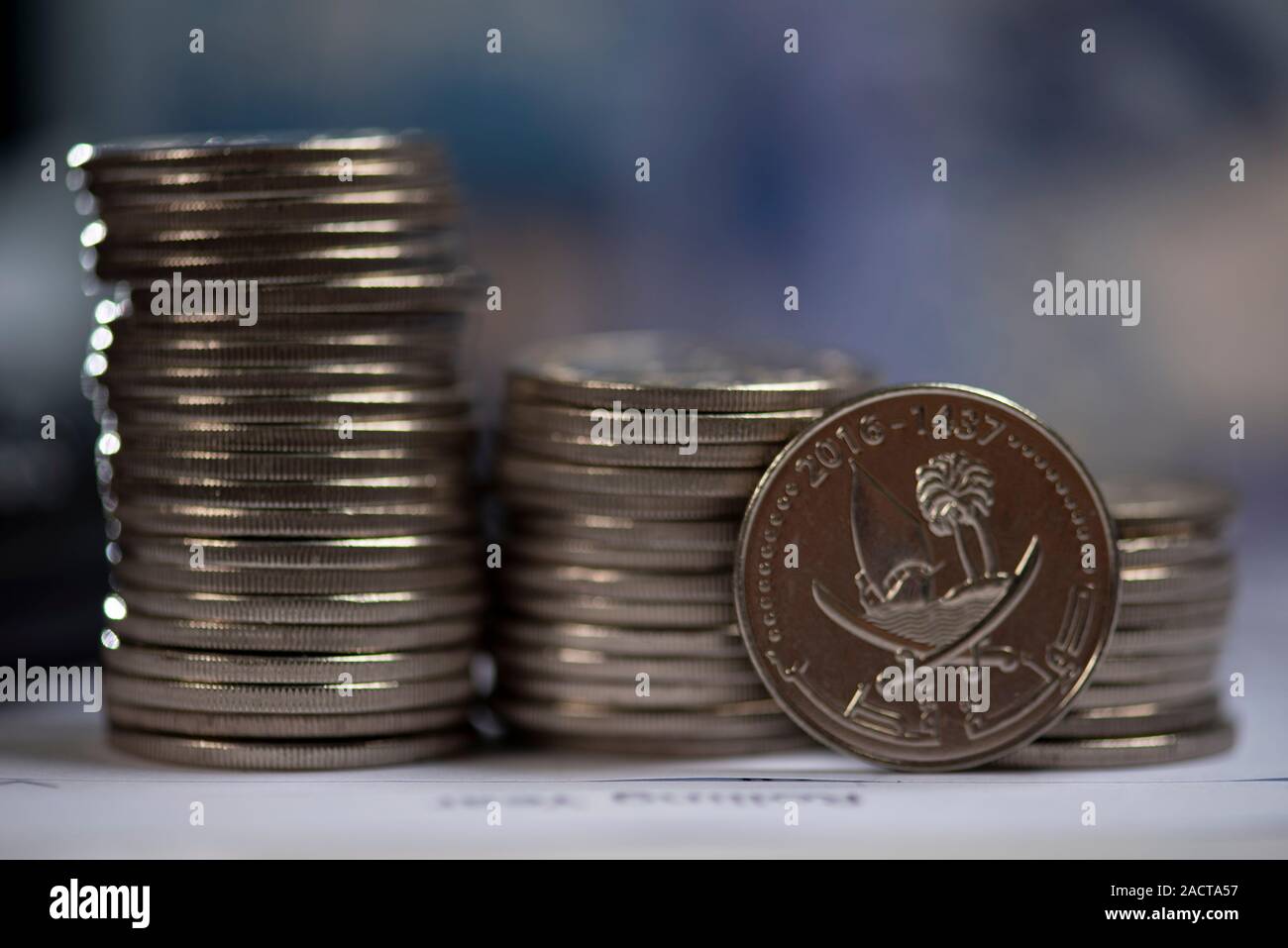Financial and business chart and graphs, Qatari money coin and ...