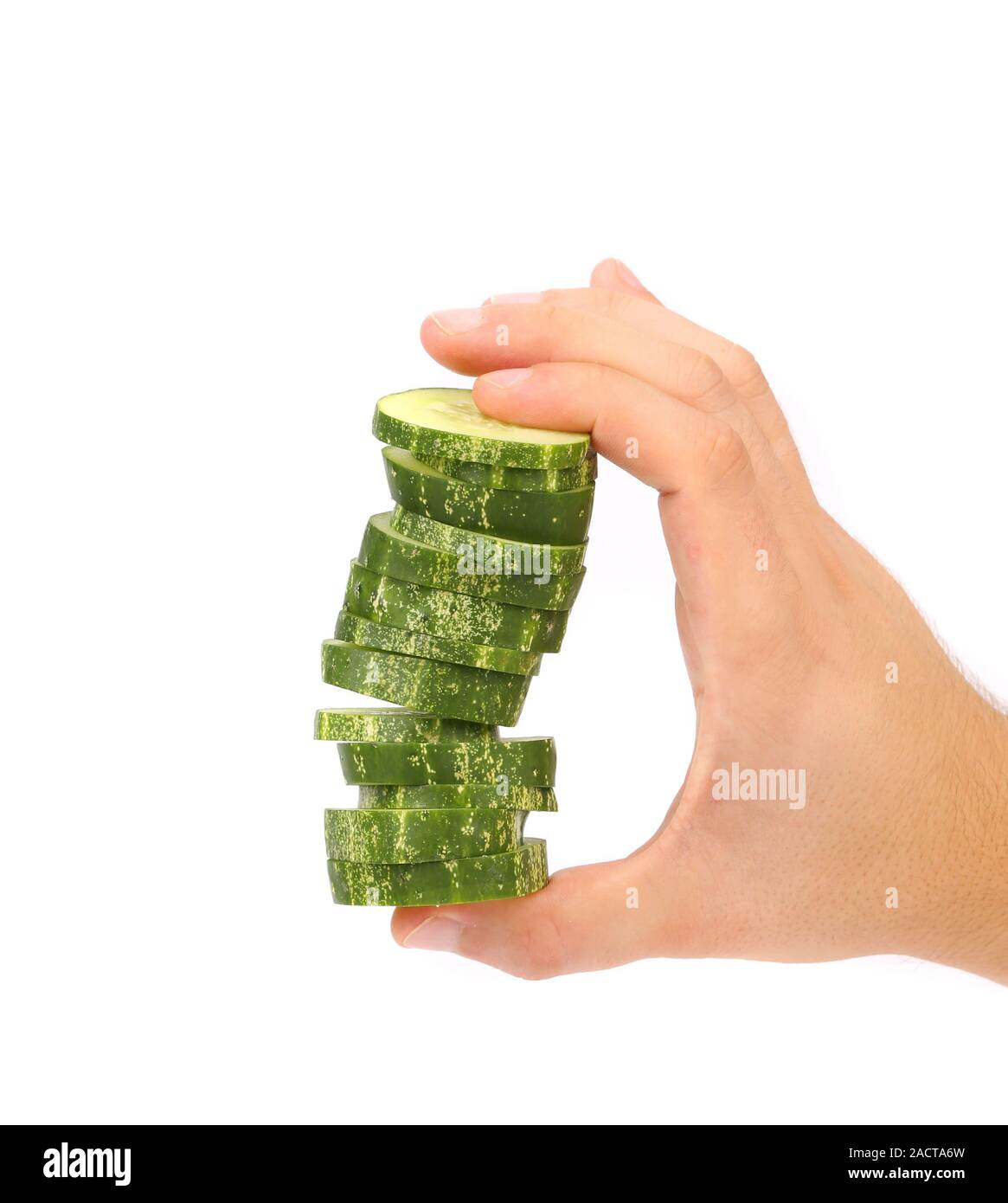 Hand holds stack of sliced cucumber. Stock Photo