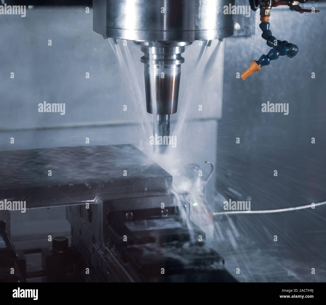 CNC milling machine cutting workpiece with coolant Stock Photo Alamy