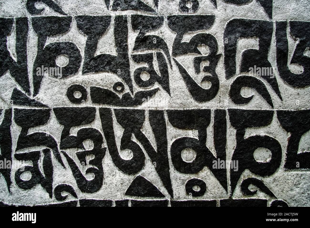Mani Stone With The Engraved Tibetan Mantra Om Mani Padme Hum Stock mani-stone-with-the-engraved-tibetan-mantra-om-mani-padme-hum-stock