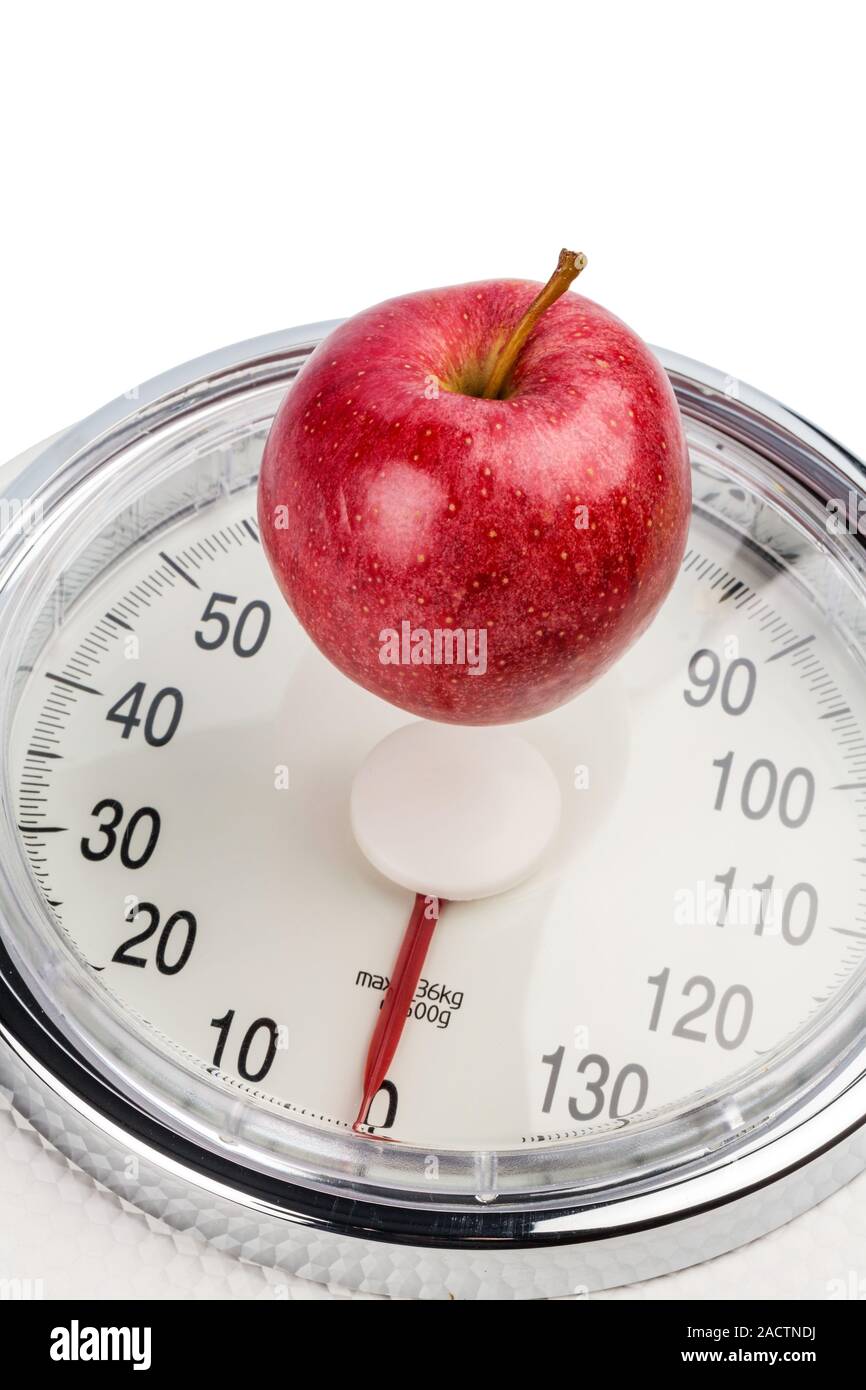Apple lies on a scale Stock Photo - Alamy