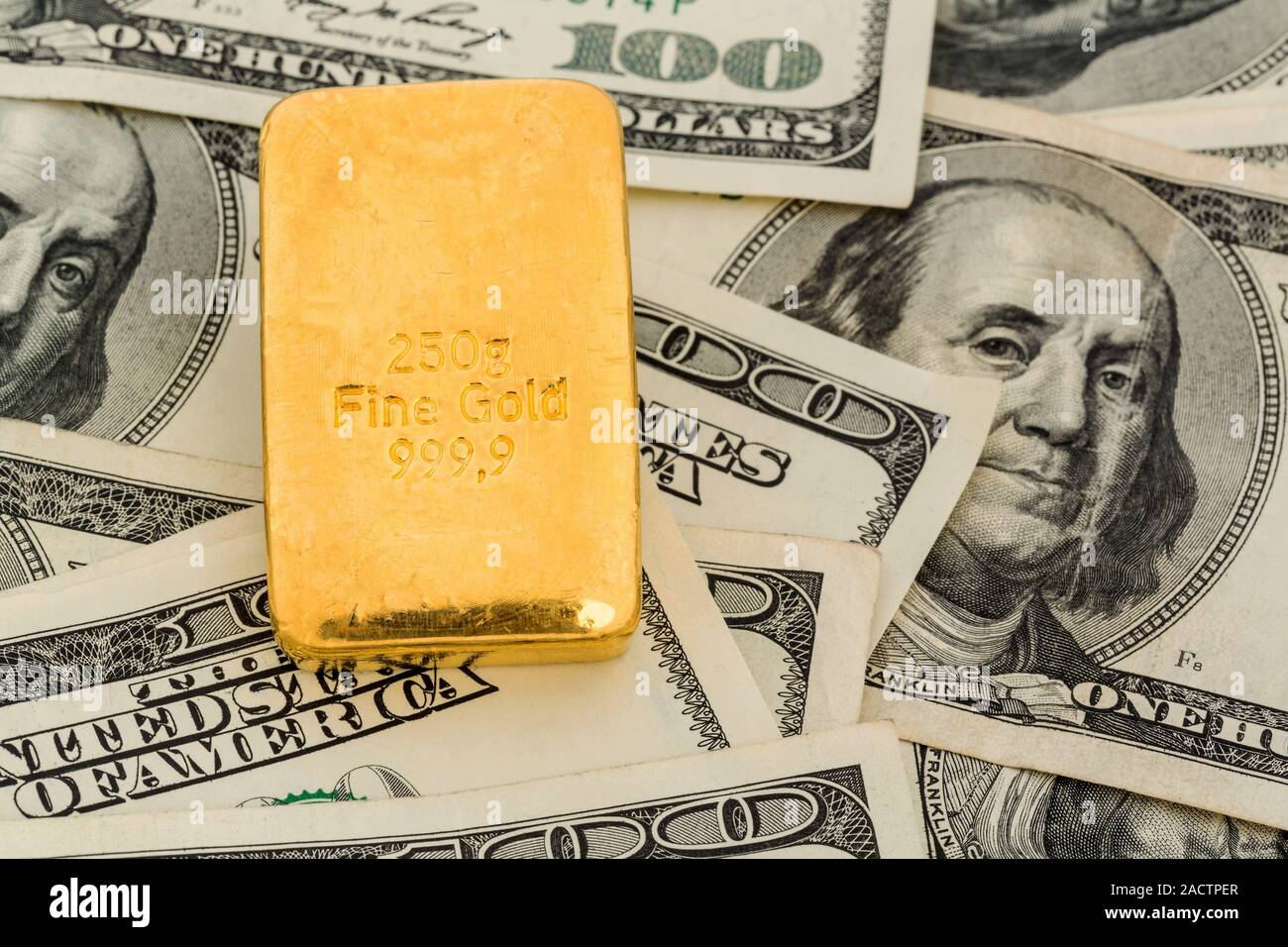 Gold bars on dollar bills Stock Photo Alamy