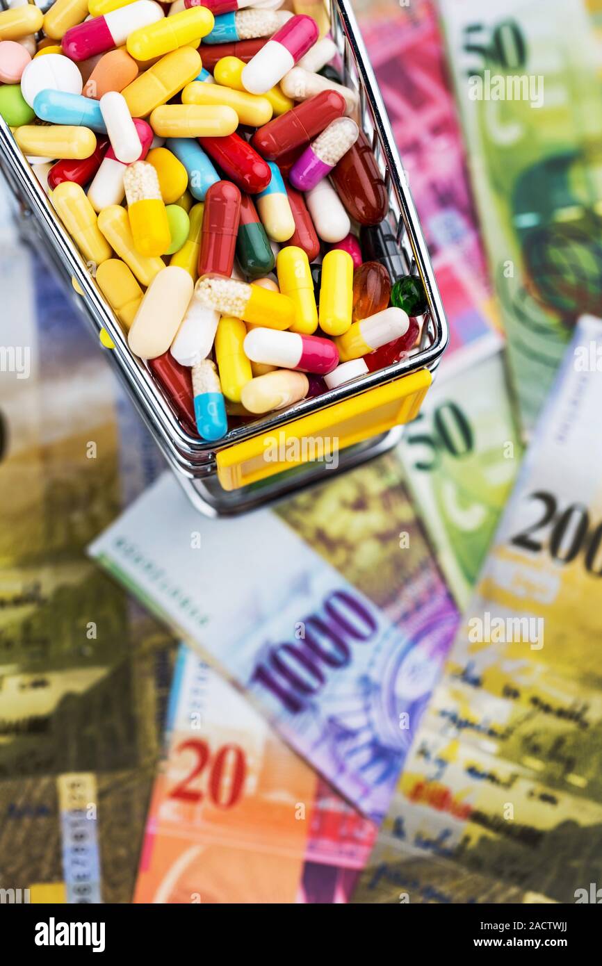 Tablets, shopping trolleys, banknotes Stock Photo