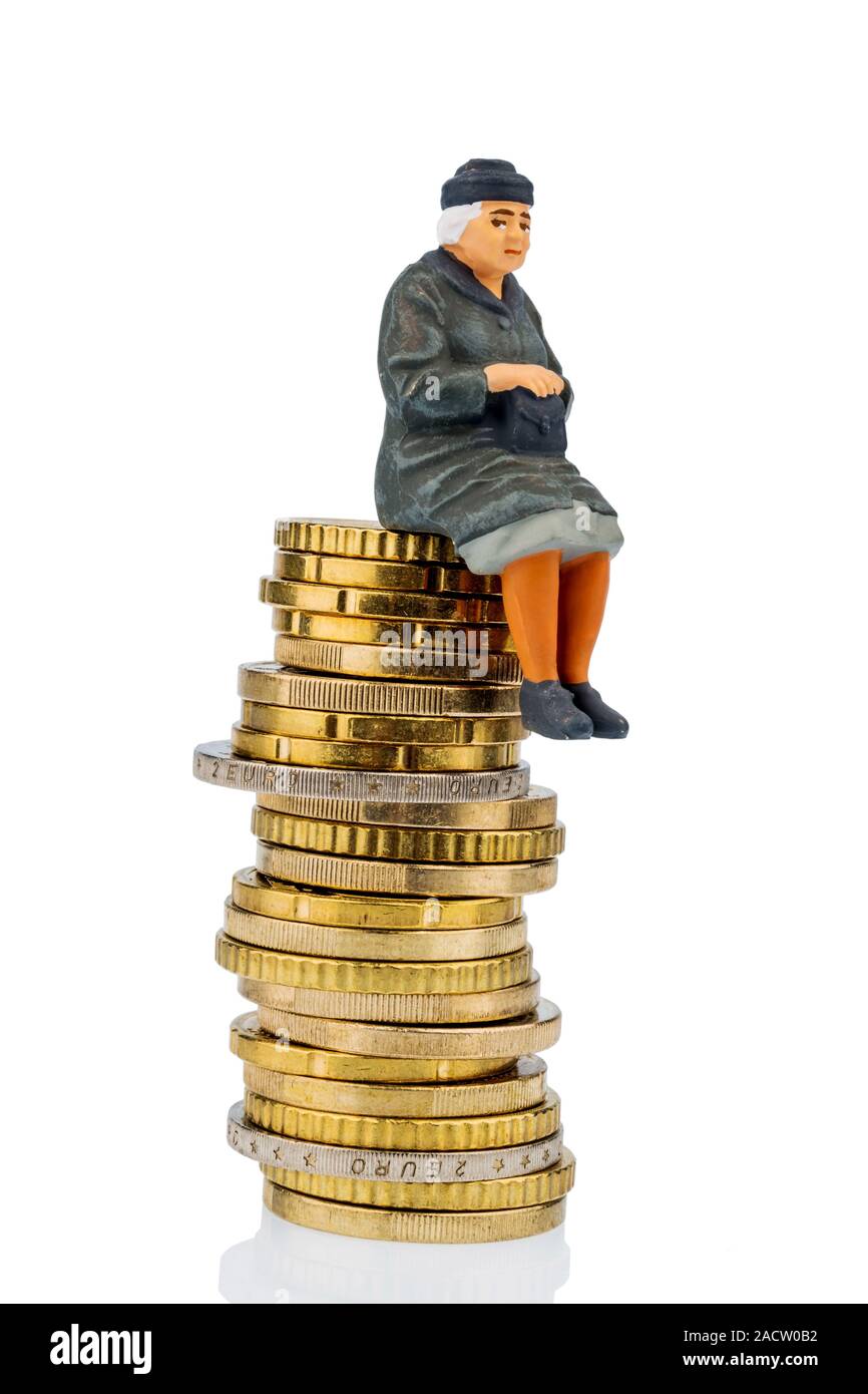 Pensioner sitting on a pile of money Stock Photo