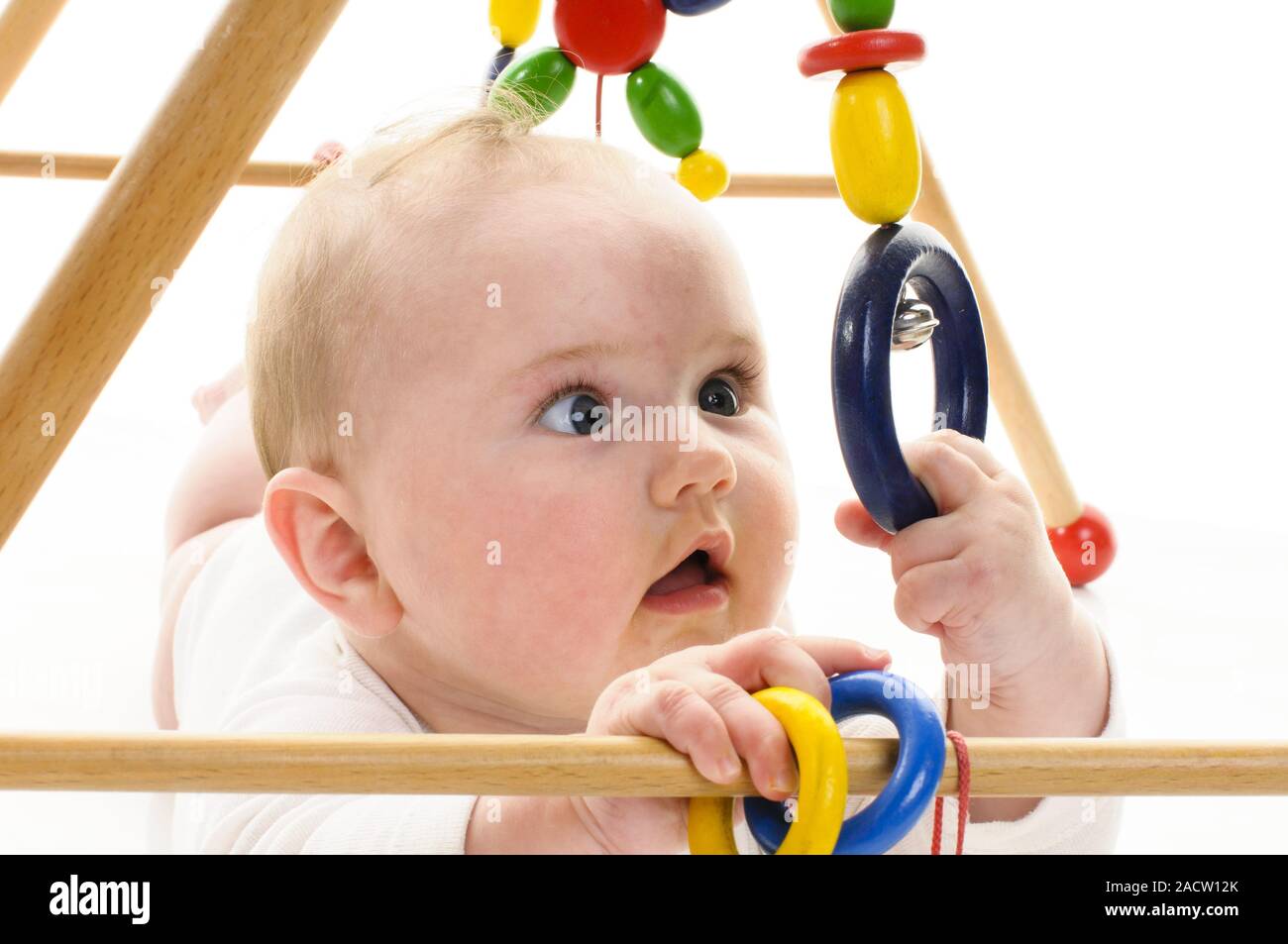 Baby with gripping toy Stock Photo