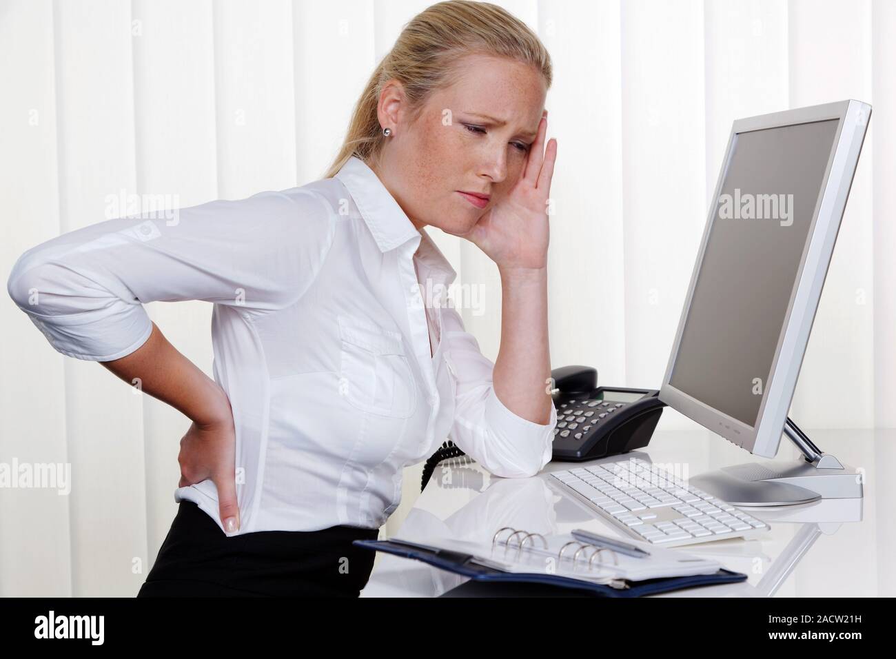 Woman with back pain in the office Stock Photo - Alamy