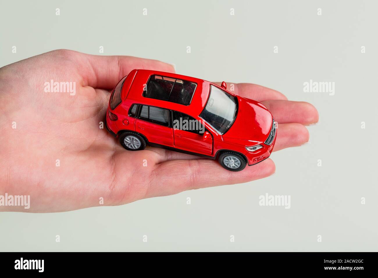 Hand holds model of a car Stock Photo Alamy