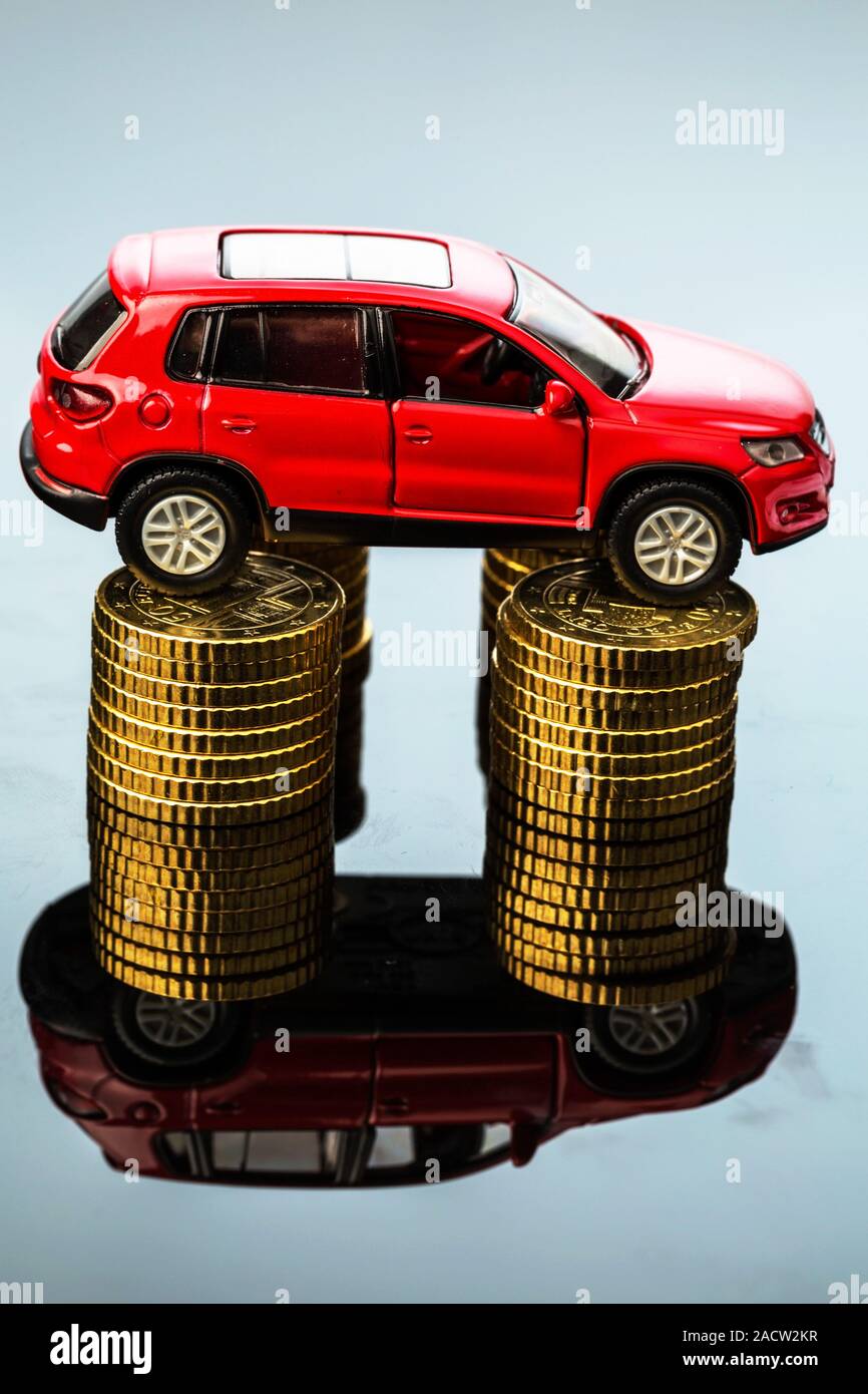 Rising car costs. Car on coins Stock Photo