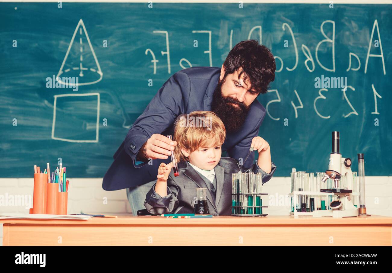 Basic Upbringing Teacher and child school classroom. Chemistry lesson. Lab experiment ...