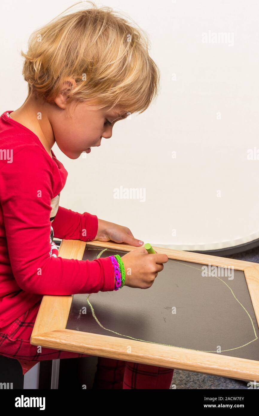 Schoolchild with blackboard Stock Photo