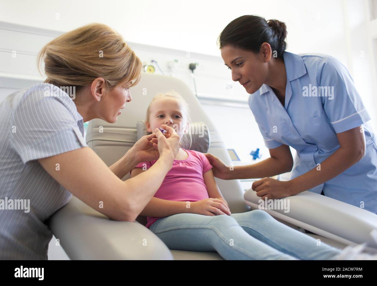 Administering antibiotics. Syringe filled with strawberry flavour antibiotic mixture being given