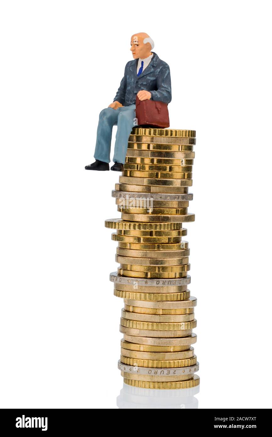 Pensioner sits on pile of money Stock Photo