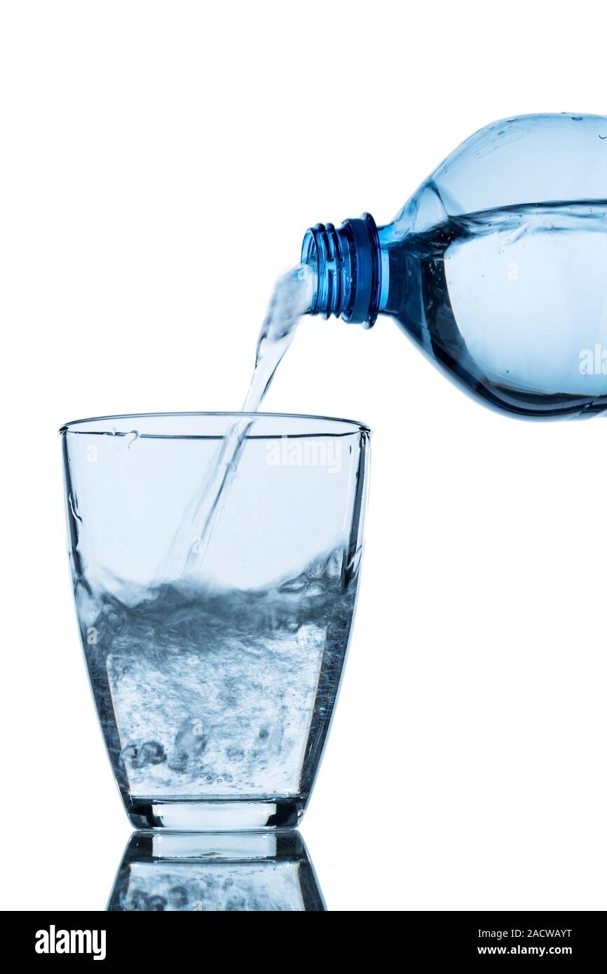 Pour water into a glass Stock Photo