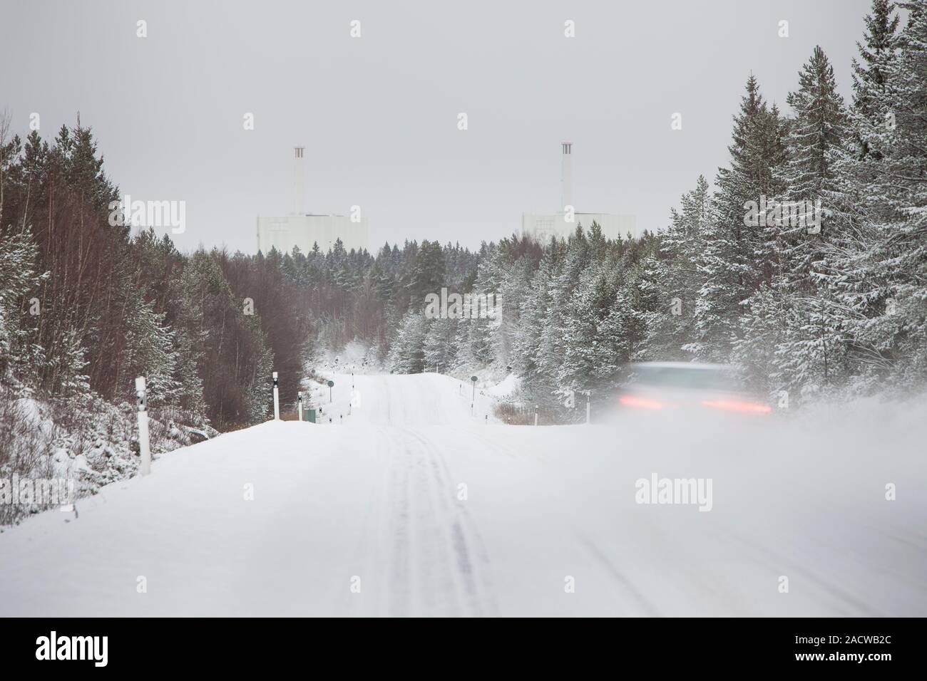 Winter road in a forest  leading to the Forsmark nuclear power plant , Uppland, Sweden, Scandinavia. Stock Photo