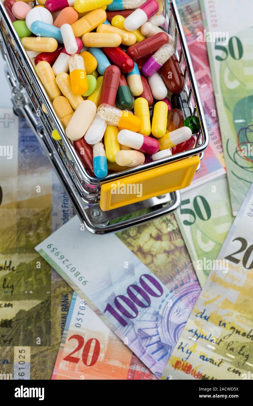 Tablets, shopping trolleys, banknotes Stock Photo