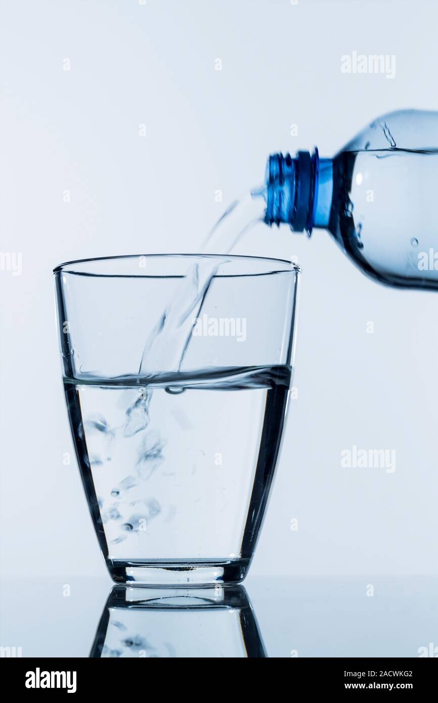 Pour water into a glass Stock Photo