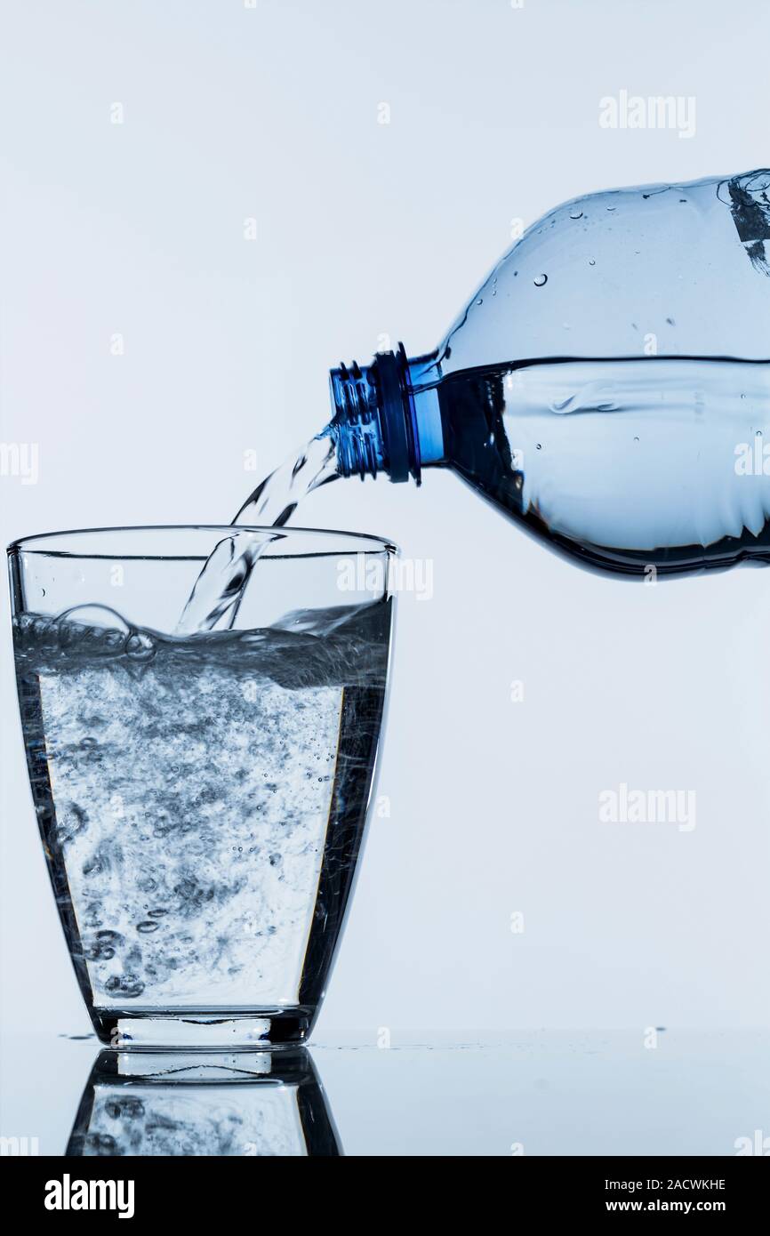Pour water into a glass Stock Photo