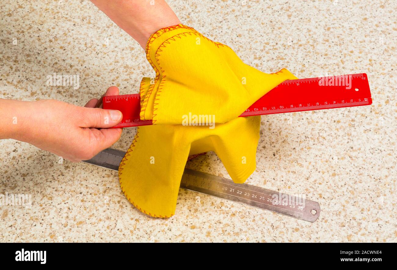 Plastic ruler being rubbed with a duster. Some materials can take up a