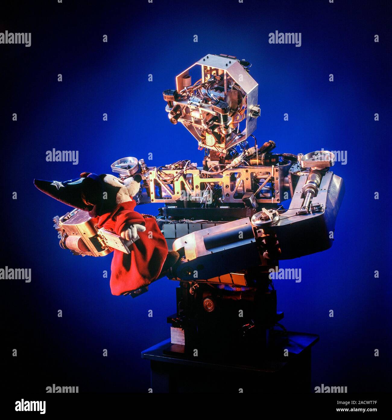 Cog android robot holding a stuffed toy. Cog (short for cognitive) is a robotic platform that