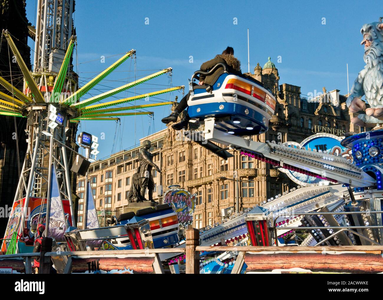 Yeti and Star Flyer fairground rides. Edinburgh Christmas Market and Fair. Jenners Department store on Princes Street in background. Scotland Stock Photo