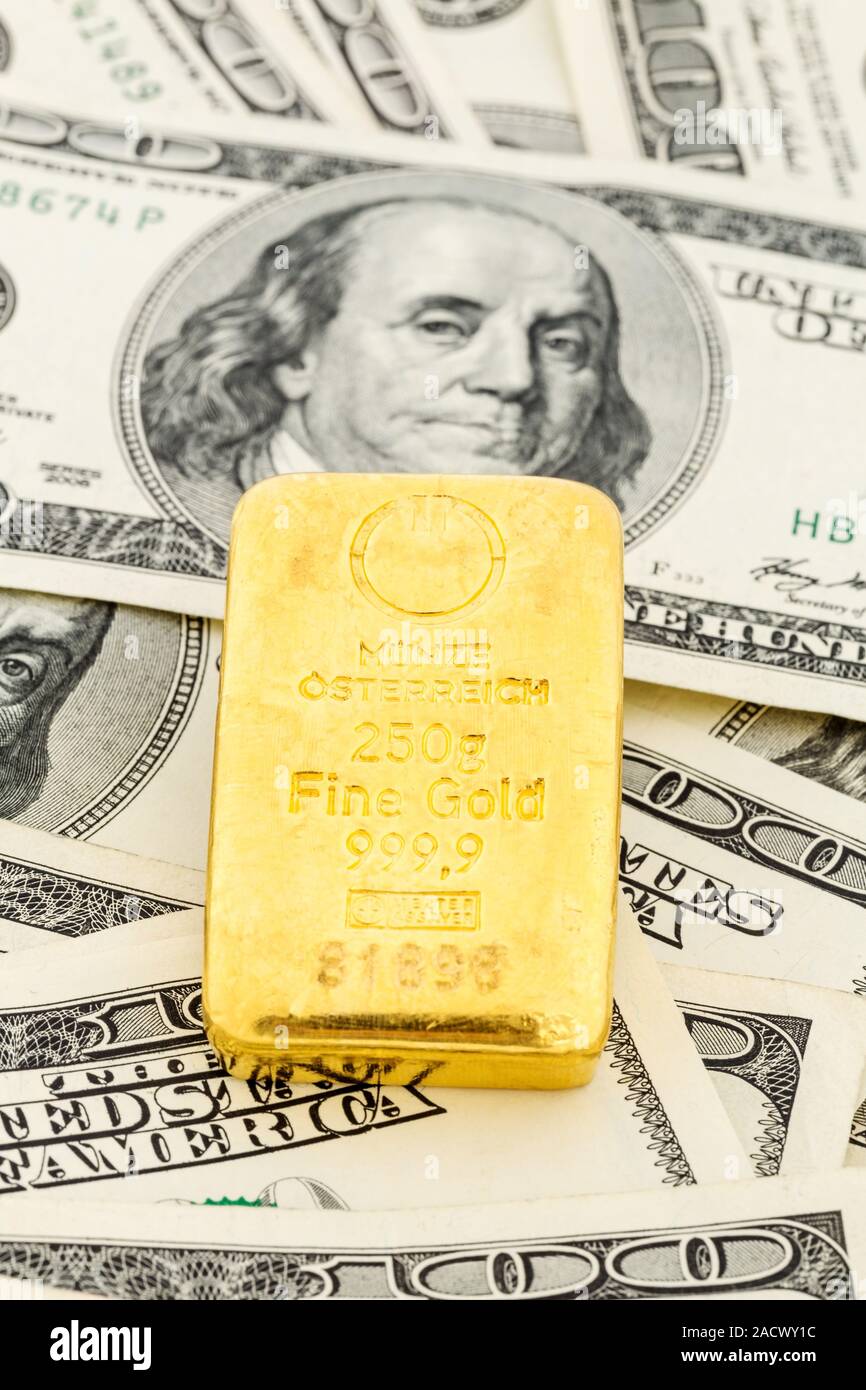 Gold bars on dollar bills Stock Photo