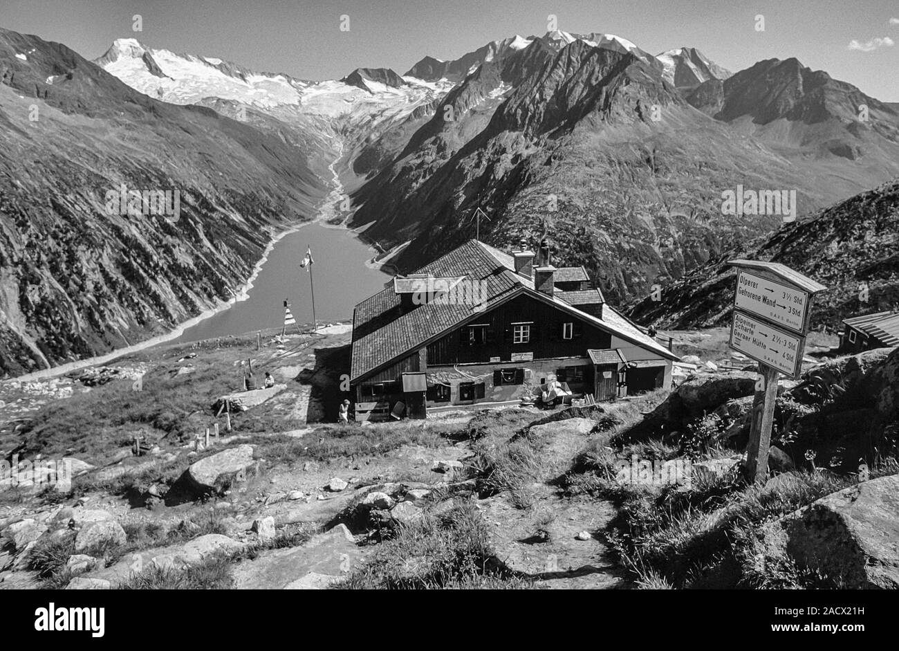 The German Alpine Club, Olperer Hut mountain refuge in the Zilletal Alps of the Austrian Tirol on the Berliner Hoehen Weg long distance walking trail as it was in 1992. The hut suffered severe avalanche damage in 1998. The hut has since been replaced with a new hut. The hut overlooks the Schlegies reservoir and the main peaks of the Zillertal Alps Stock Photo