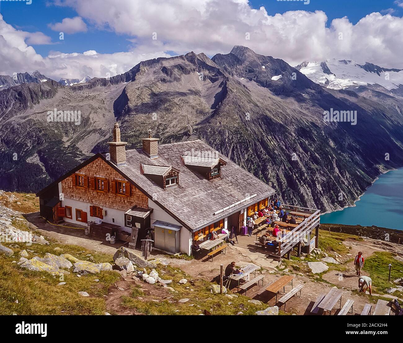 The German Alpine Club, Olperer Hut mountain refuge in the Zilletal Alps of the Austrian Tirol on the Berliner Hoehen Weg long distance walking trail as it was in 1997. The hut suffered severe avalanche damage in 1998. The hut has since been replaced with a new hut. The hut overlooks the Schlegies reservoir and the main peaks of the Zillertal Alps Stock Photo