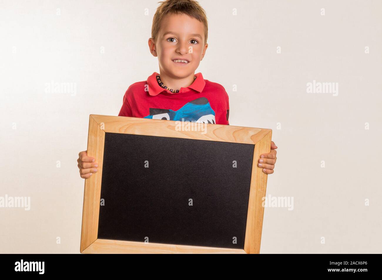 Schoolchild with blackboard Stock Photo
