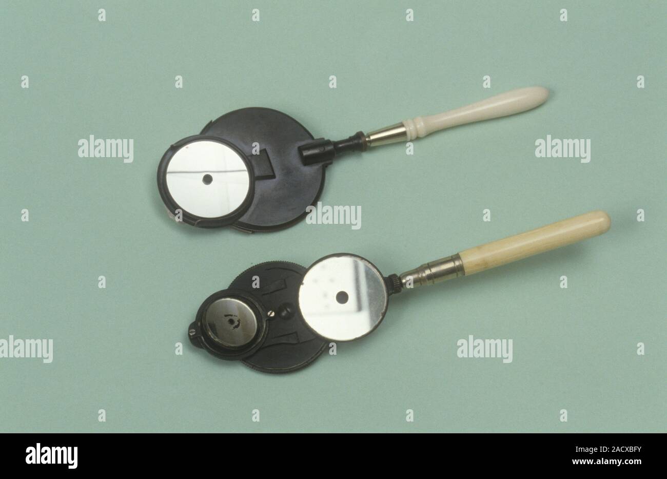Two Ivory handled ophthalmoscopes. These devices are used for visual ...