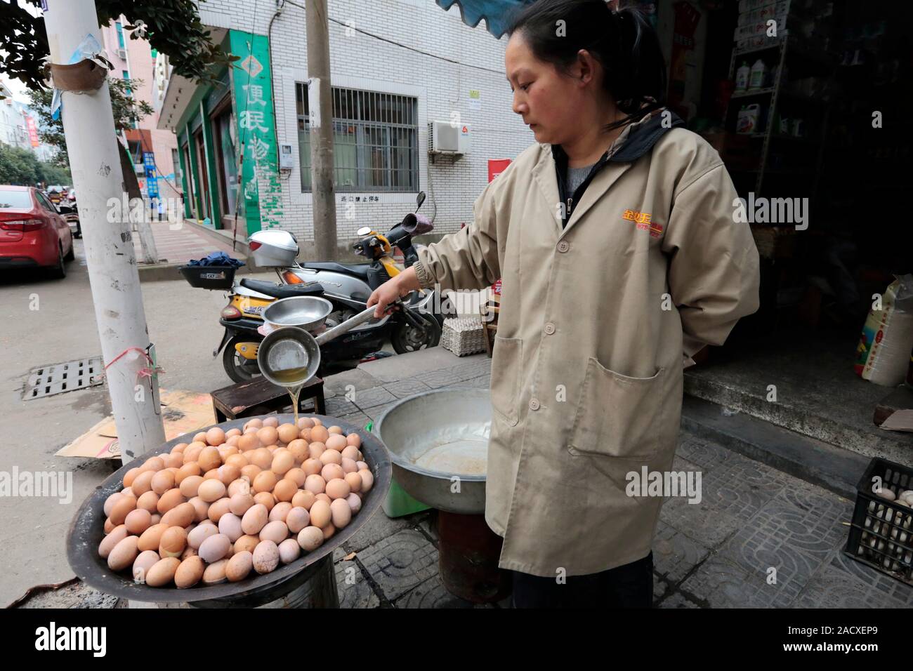 Cooking eggs with urine. A woman is pouring hot urine over eggs to cook