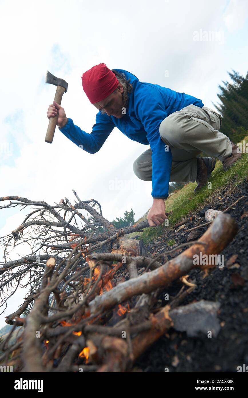 hiking man try to light fire Stock Photo