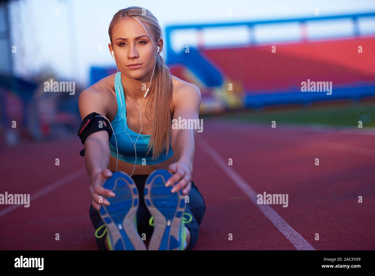 sporty woman on athletic race track Stock Photo - Alamy