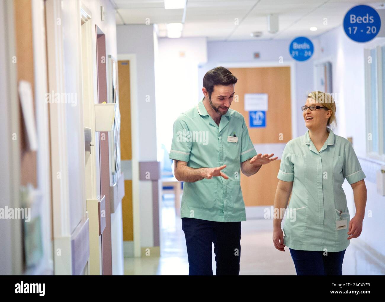 Apprentice clinical support workers walking along a hospital corridor. Stock Photo