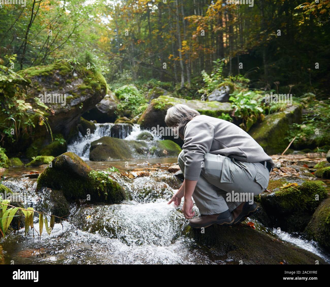 man drinking fresh water from spring Stock Photo Alamy