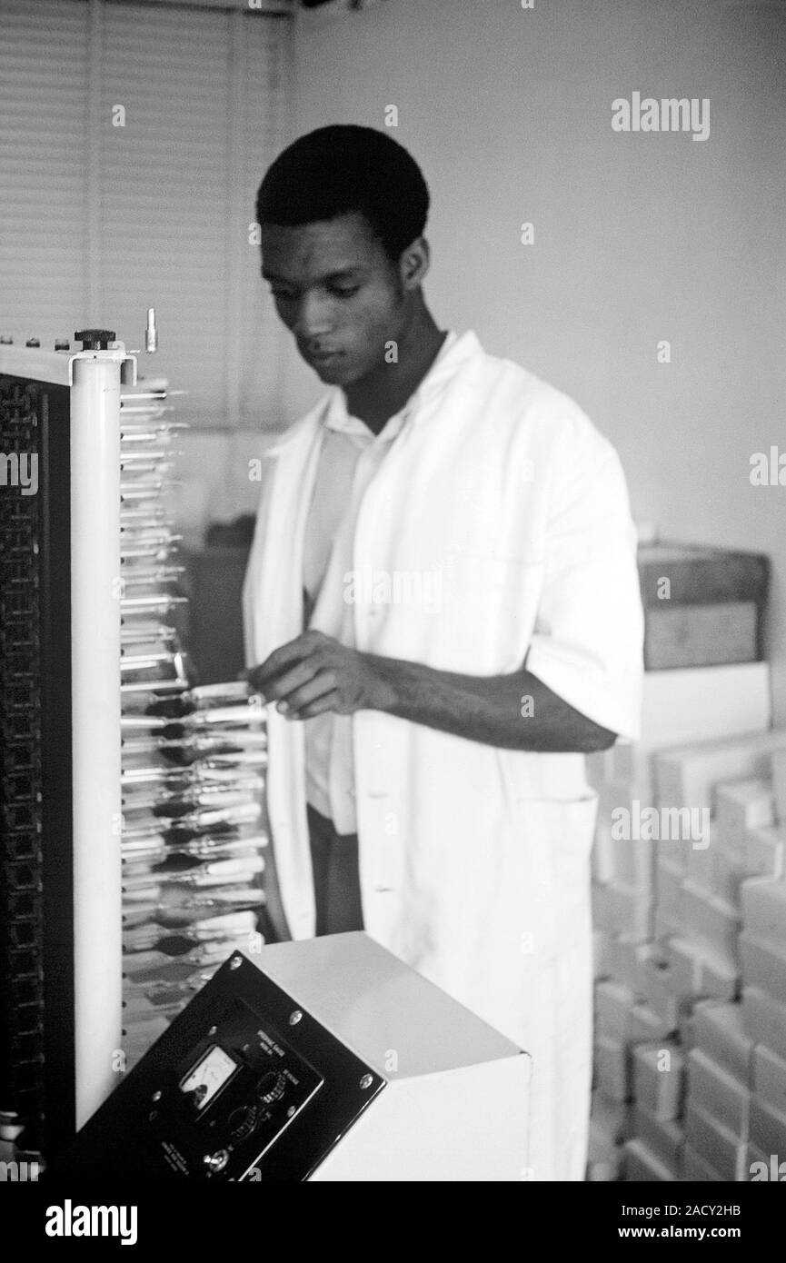 Smallpox vaccine production. Laboratory technician using a machine ...