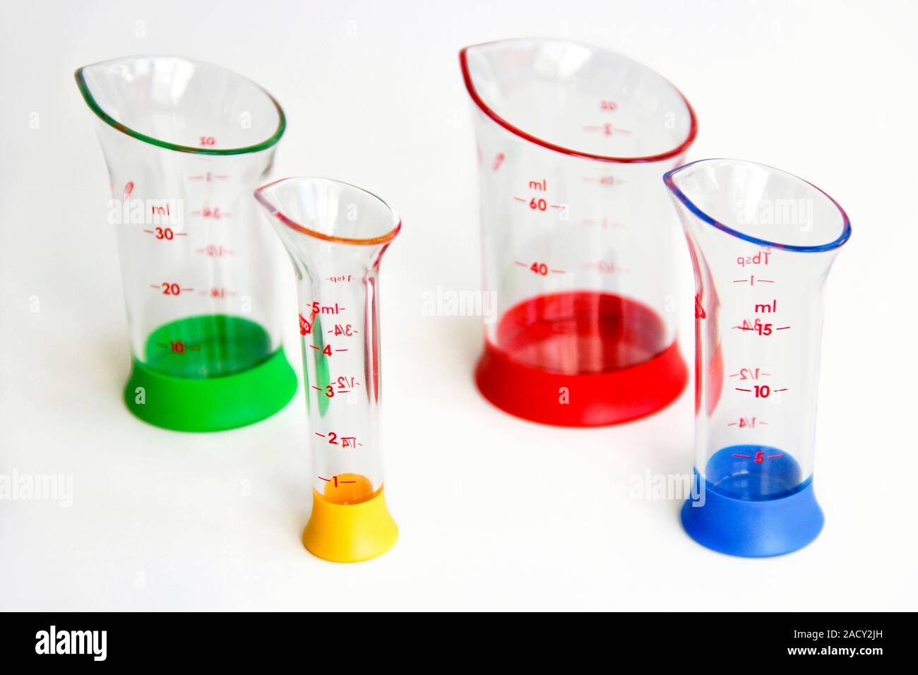Laboratory measuring flasks. Various coloured flasks used to measure
