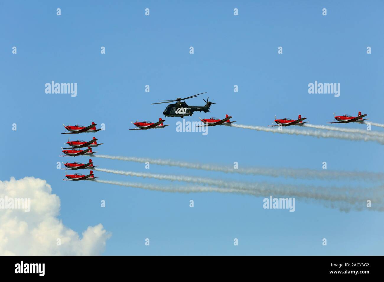 Payerne Airshow, Swiss PC-7 team and helicopter in formation flight Stock Photo