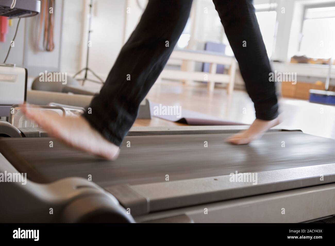 Treadmill exercise. Closeup of a physiotherapy patient walking on a treadmill while recovering