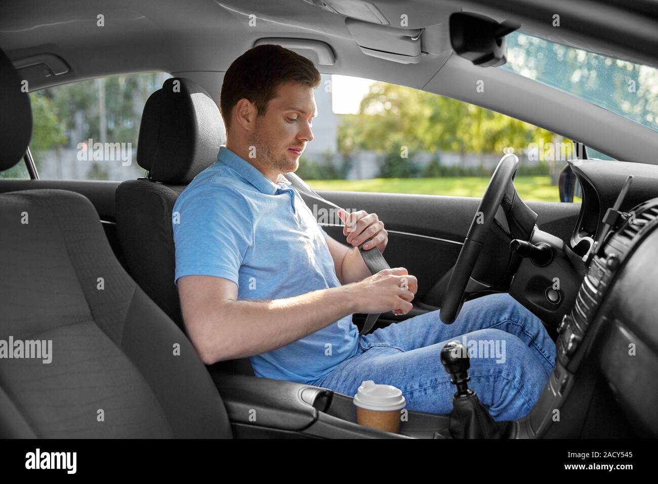 https://c8.alamy.com/comp/2ACY545/transport-vehicle-and-safe-driving-concept-man-or-car-driver-fastening-safety-seat-belt-in-summer-2ACY545.jpg