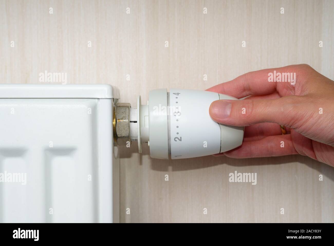 Woman Hand Adjusting The Temperature By Thermostat Stock Photo - Alamy