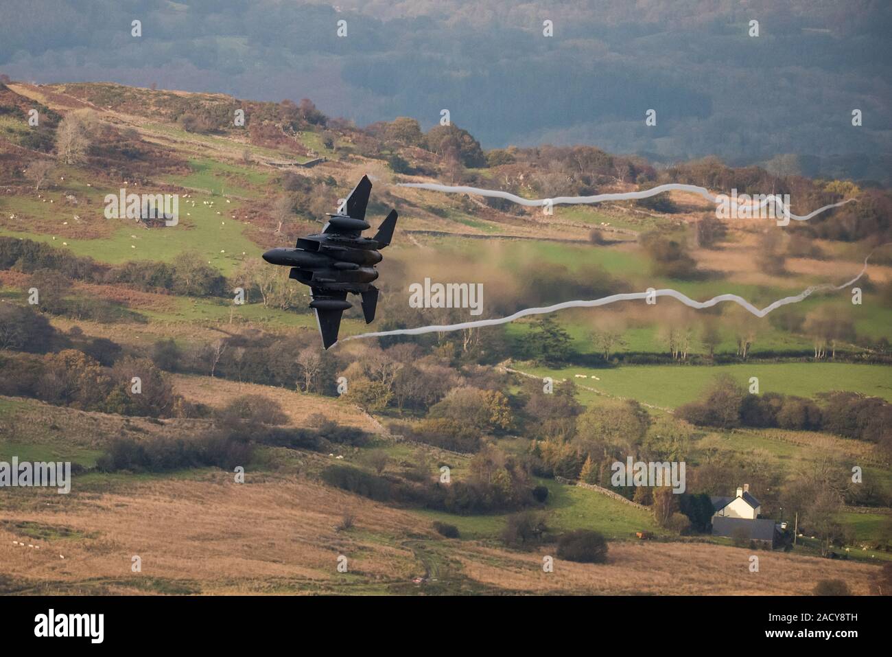 F-15 Eagle, USAF Mc Donnell Douglas low-level fighter jet flying from Valley Anglesey through the Mach Loop in Cadair Idris Wales Stock Photo