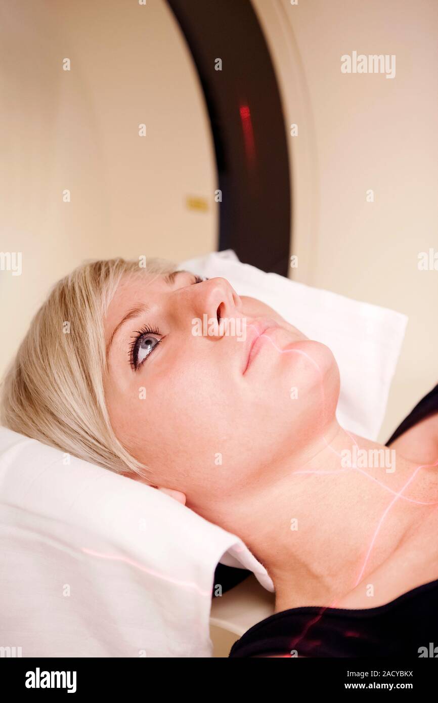 A patient ready for a CT scan. The red laser lines are used to align