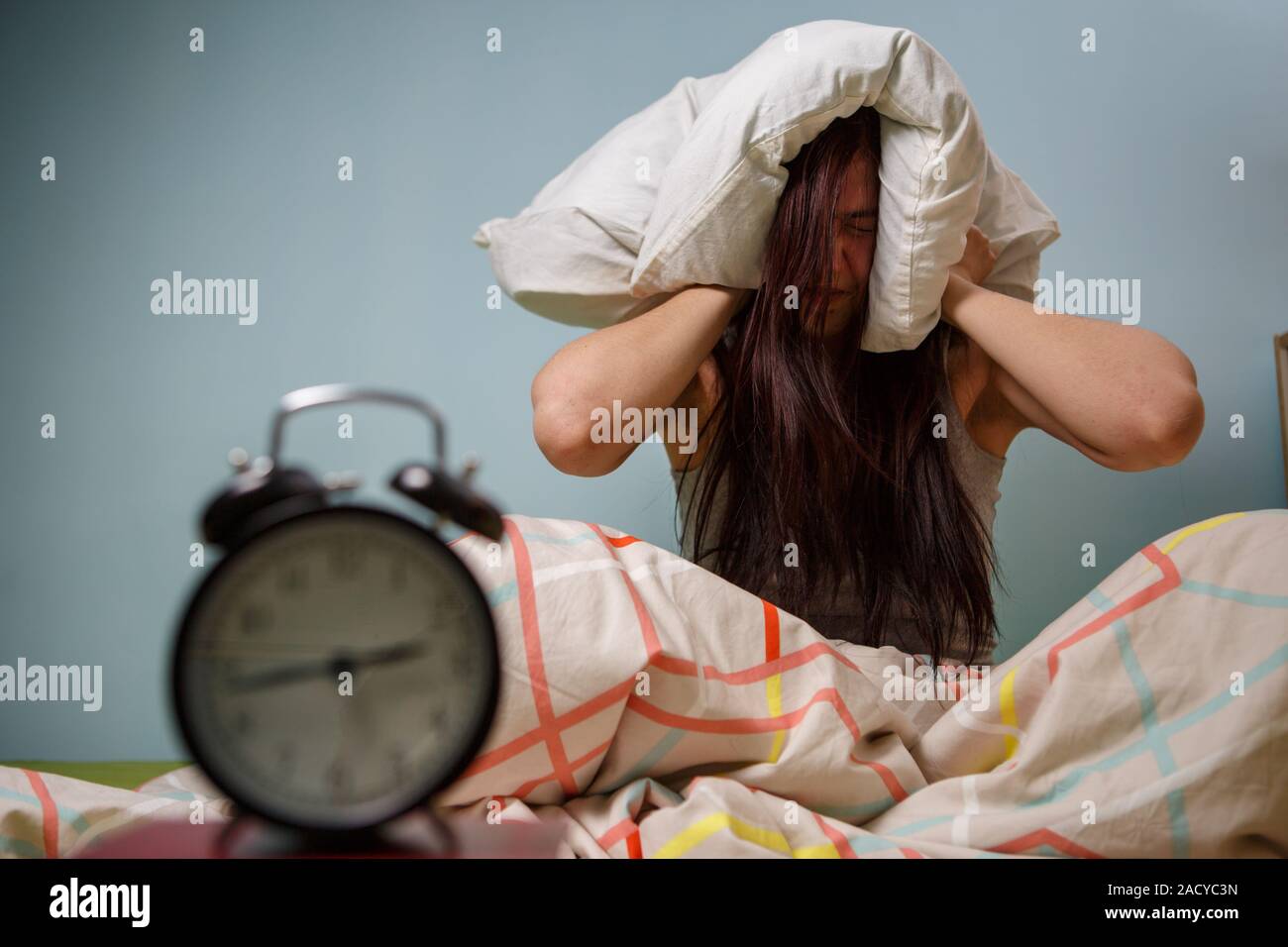 Woman with a pillow over head Stock Photo Alamy